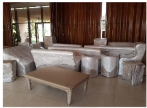 plastic wrapped furniture inside a house